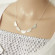 Your Scalloped Silver Necklace: A Whisper from the Sea