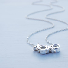 Tiny Hugs & Kisses: The Story Behind Our XOXO Necklace Charm