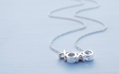 Tiny Hugs & Kisses: The Story Behind Our XOXO Necklace Charm